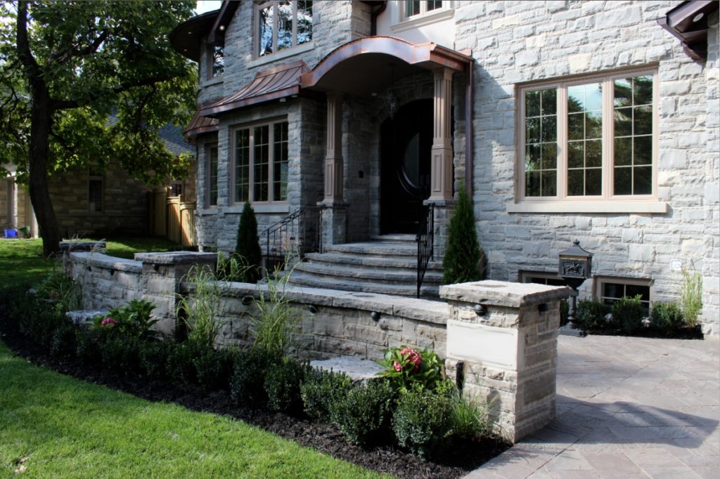 Front yard landscaping, retaining wall, rock garden, interlocking driveway, shrubs, hedge, steps